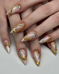 Handmade press-on nails with gold chrome, marble design, and gemstone accents