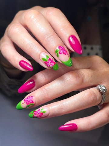 Handmade magenta pink press-on nails with green tips and tropical hibiscus flower designs.