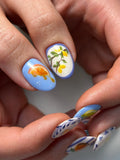 Handmade Mediterranean press-on nails with citrus fruit and blue stripe designs