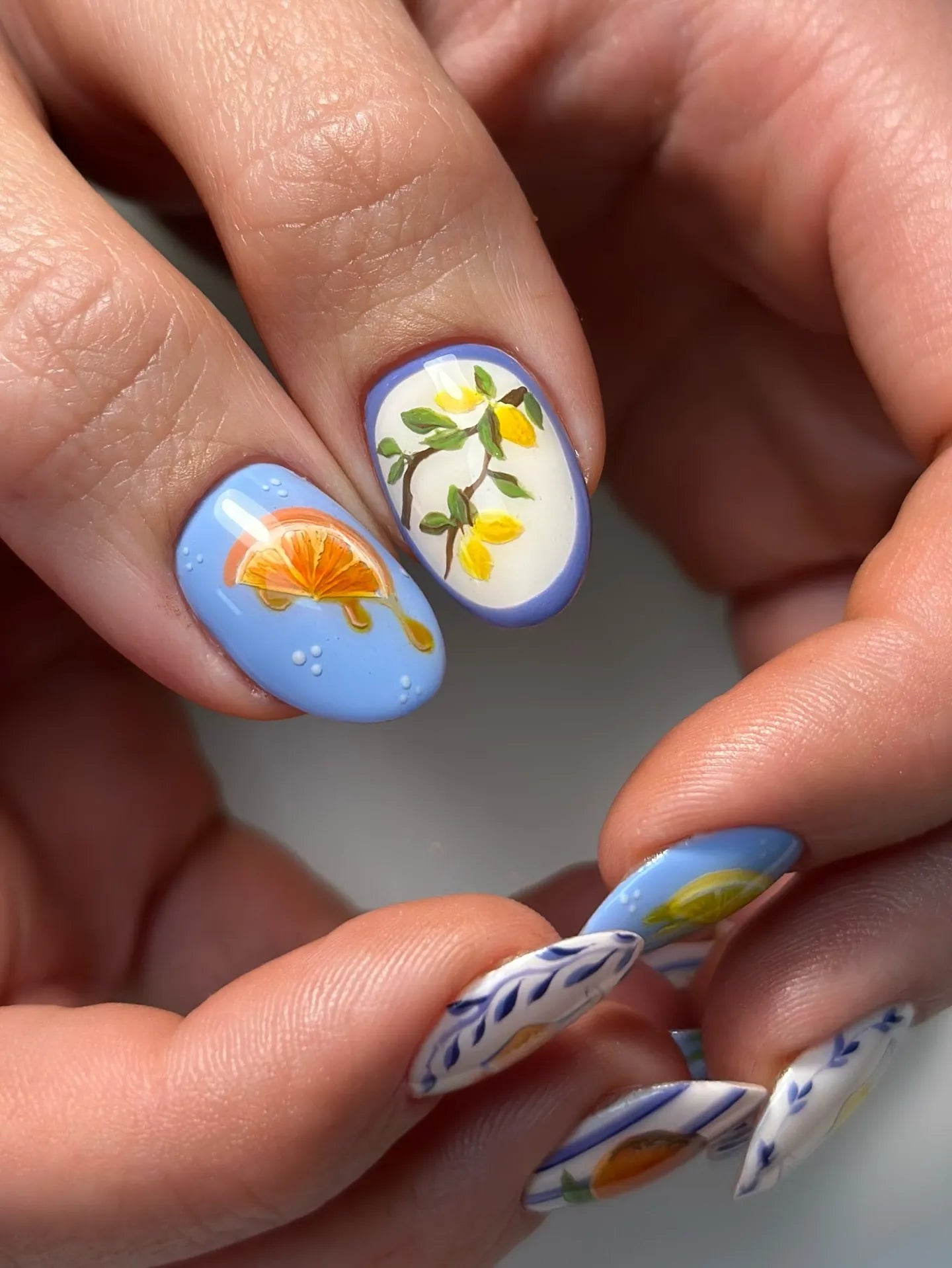 Handmade Mediterranean press-on nails with citrus fruit and blue stripe designs