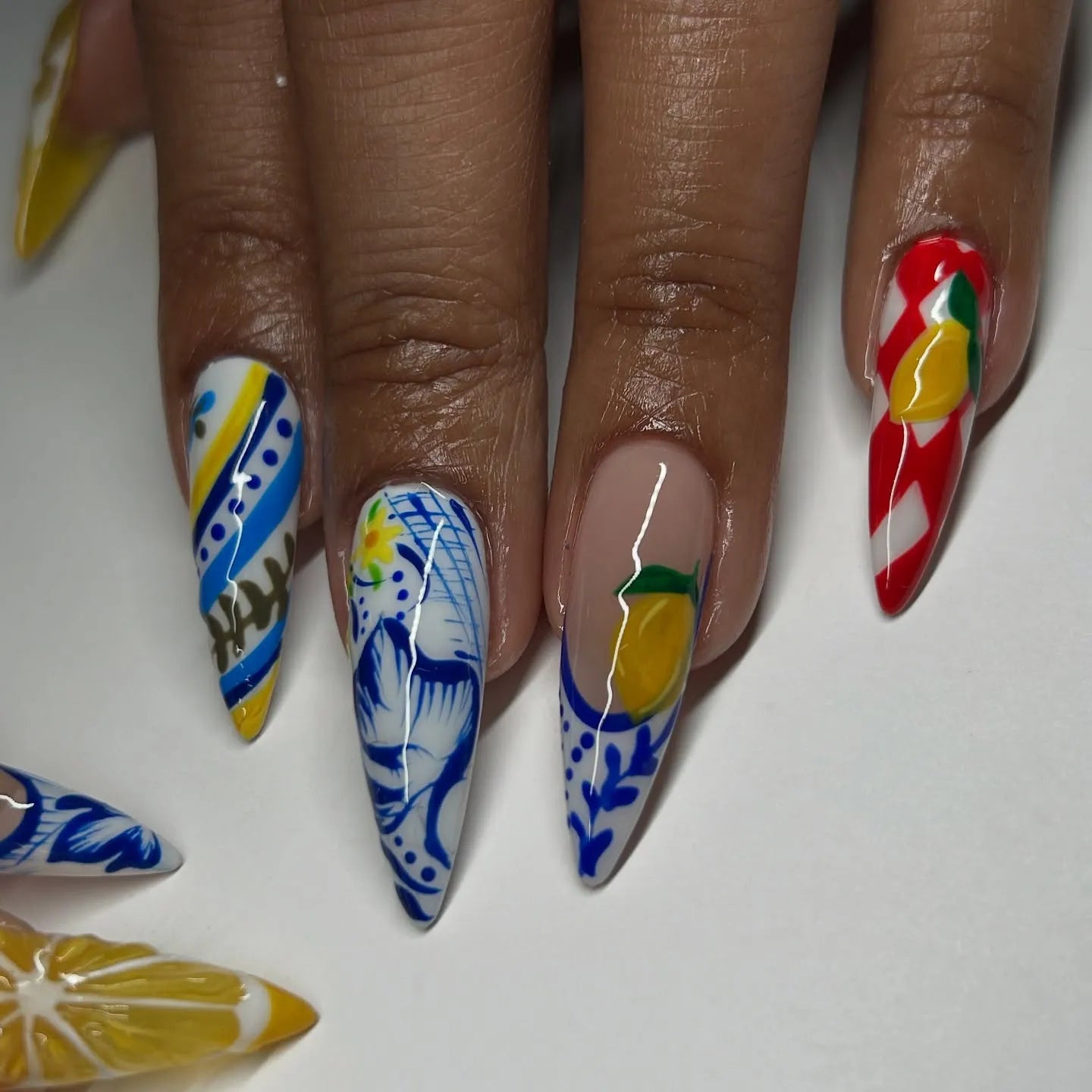 Handmade stiletto press-on nails with Mediterranean lemon and blue white Talavera designs.