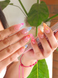 Hand holding phone with multicolor handmade floral mermaid shell press-on nails
