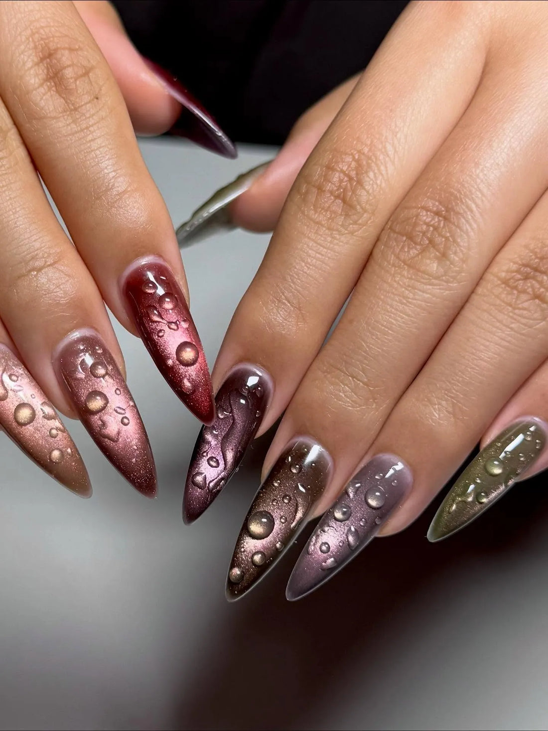 Handmade stiletto press-on nails with metallic cat-eye finish and 3D raindrop water effect