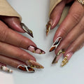 Handmade mixed tortoise shell plaid gold studded press-on nails with nude and brown accents.