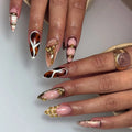 Handmade press-on nails with tortoise shell, plaid, gold studs, and abstract pink designs