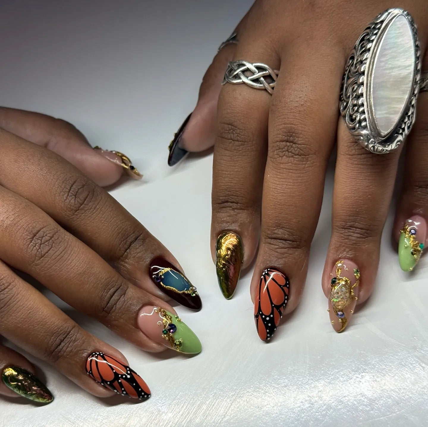 Handcrafted press-on nails with monarch butterfly art, crystal jewels, and luxury gold accents