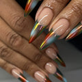 Hand with extra long stiletto press-on nails, multi-color chrome French tips