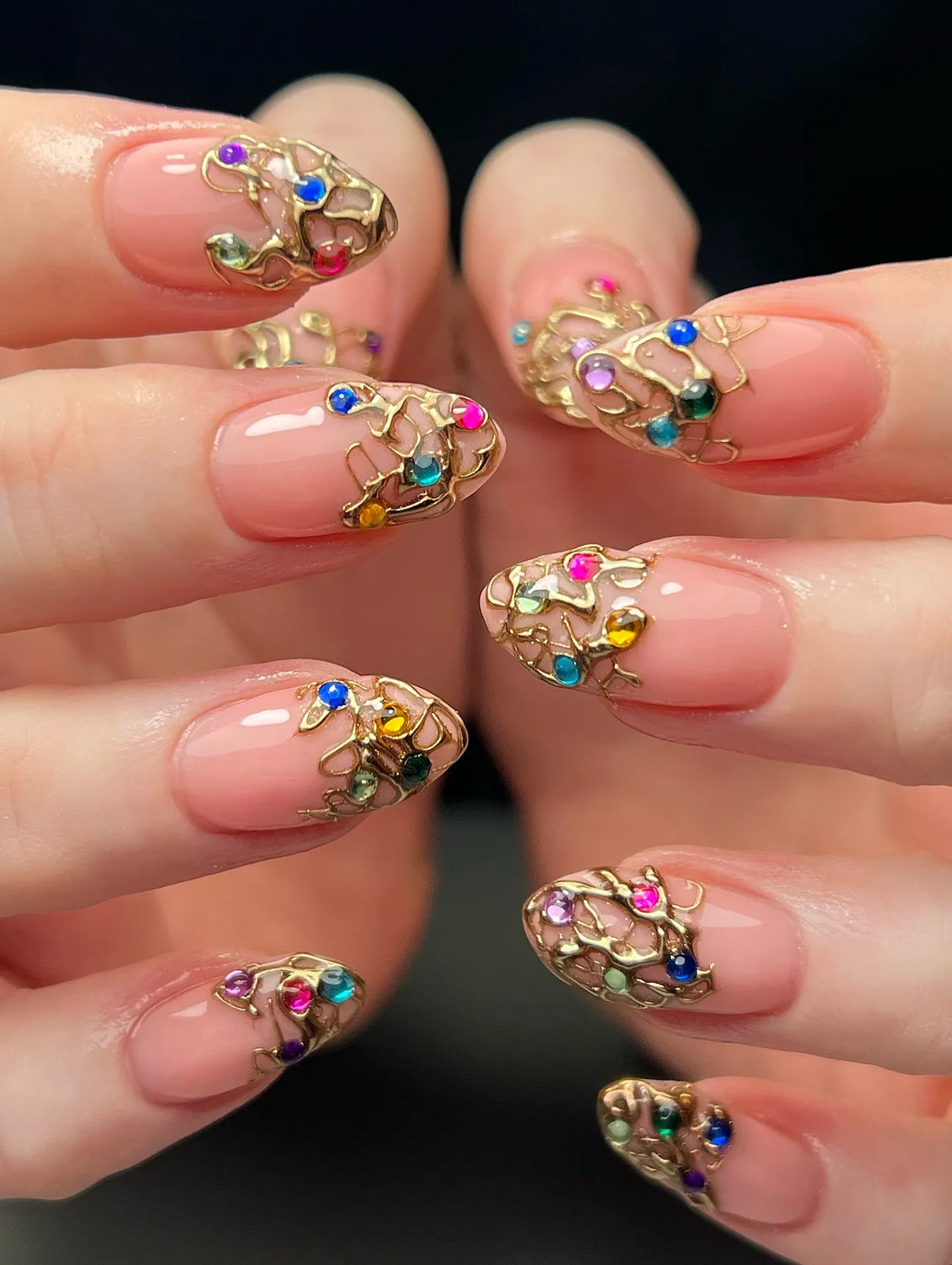 Handmade almond press-on nails with gold filigree and multicolor gemstone accents