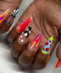 Hand with handmade long stiletto press-on nails in abstract neon 3D textured designs