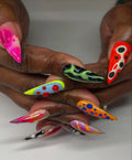 Handmade long stiletto press-on nails with neon abstract frog-inspired 3D patterns.