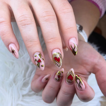 Handmade nude press-on nails with red heart and gold chrome flame nail art designs