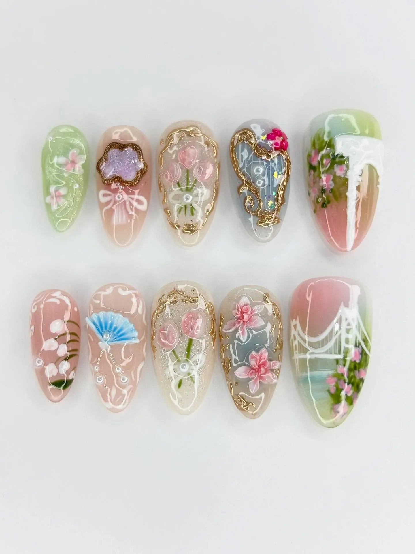 Handmade press-on nails with oriental floral, gold accents, fan and bridge designs in pastel colors