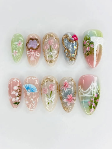 Handmade press-on nails with oriental floral, gold accents, fan and bridge designs in pastel colors