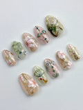 Handmade press-on nails with oriental floral, jade, fan, and gold shimmer designs