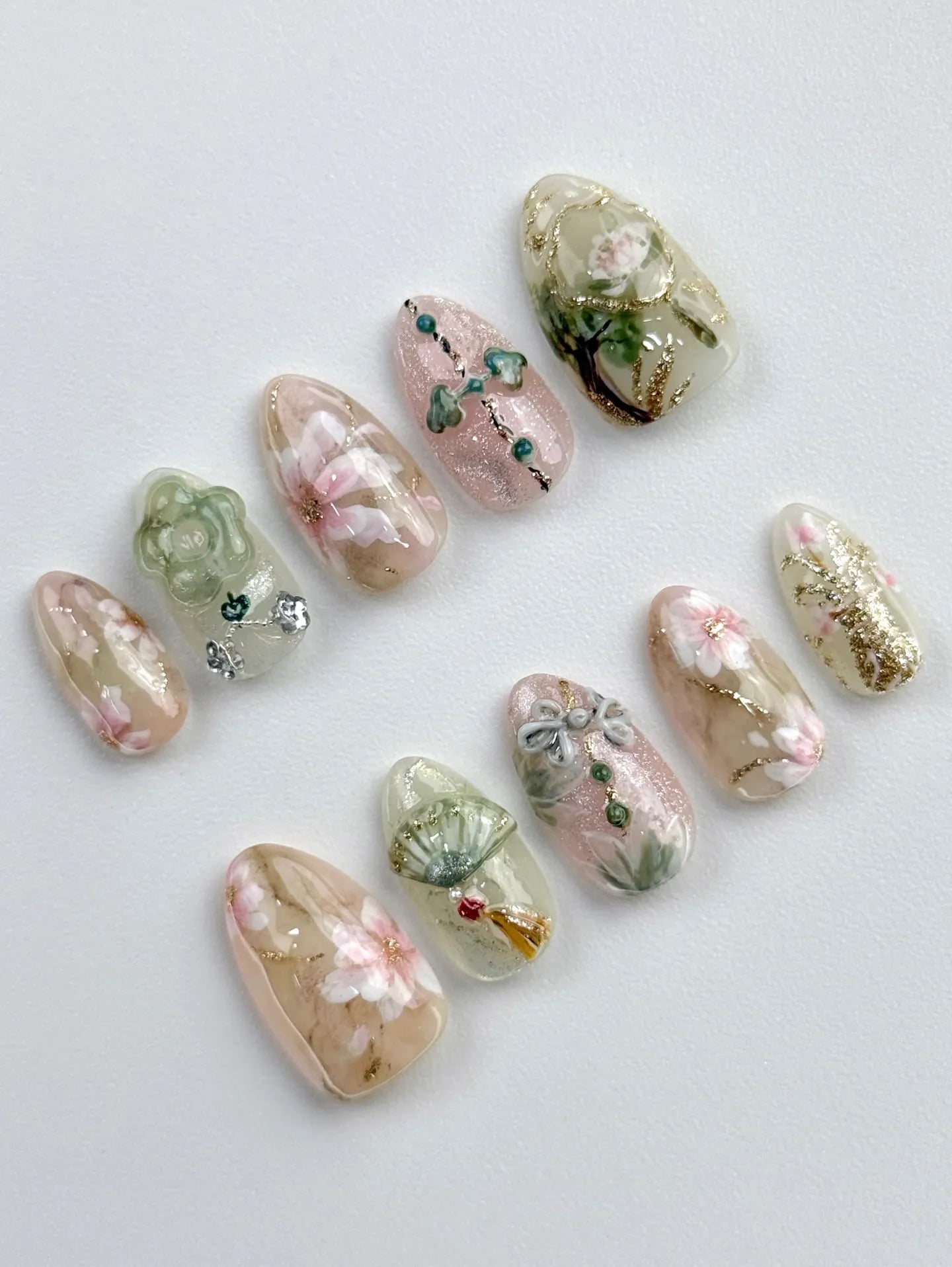 Handmade press-on nails with oriental floral, jade, fan, and gold shimmer designs