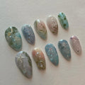 Handmade pale blue press-on nails with ocean, jellyfish, water lily, and silver accents