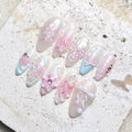 Handmade pastel press-on nails with butterfly, bow, flower, and pearl shimmer details