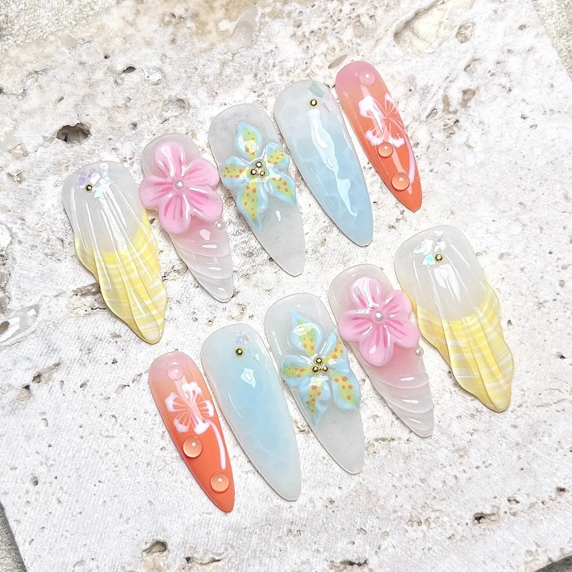 Handmade pastel mermaid press-on nails with 3D flowers, jellyfish, shells, and pearl gems.