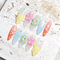Handmade pastel ocean-themed press-on nails with 3D flowers, jellyfish, shell, and pearl accents