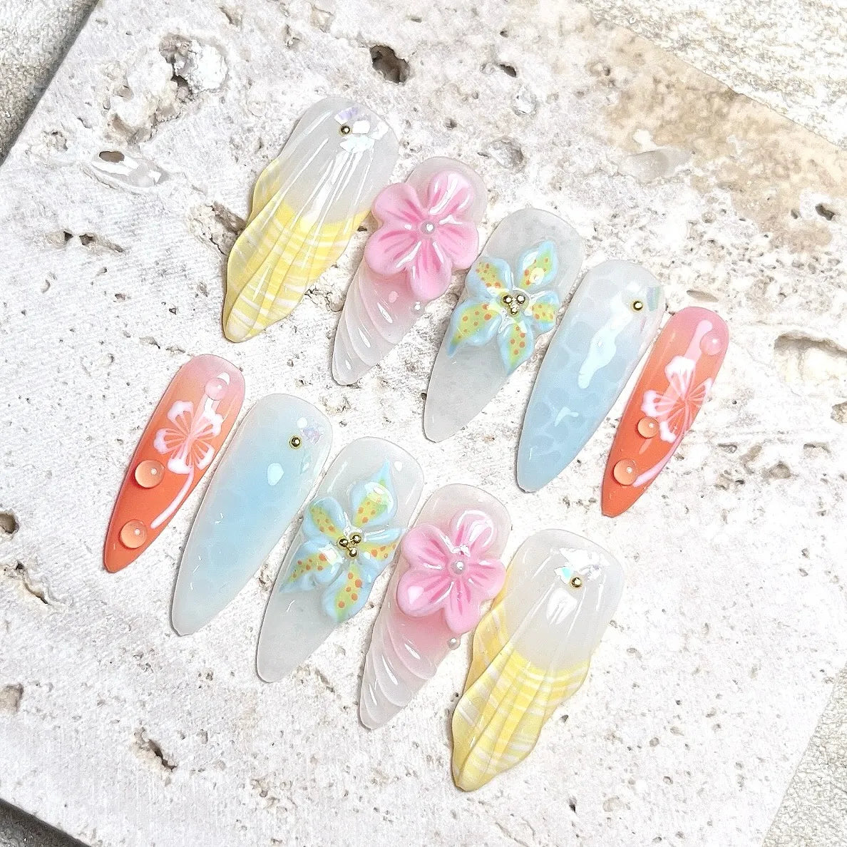 Handmade pastel ocean-themed press-on nails with 3D flowers, jellyfish, shell, and pearl accents