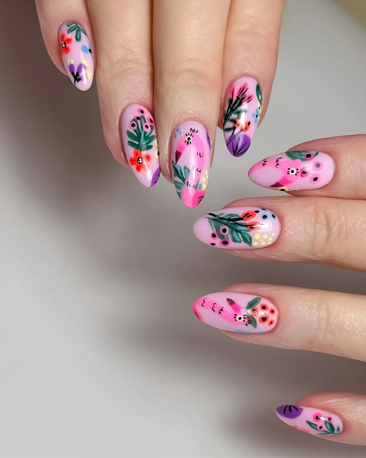 Handmade pink press-on nails with abstract garden berries and floral artistic design