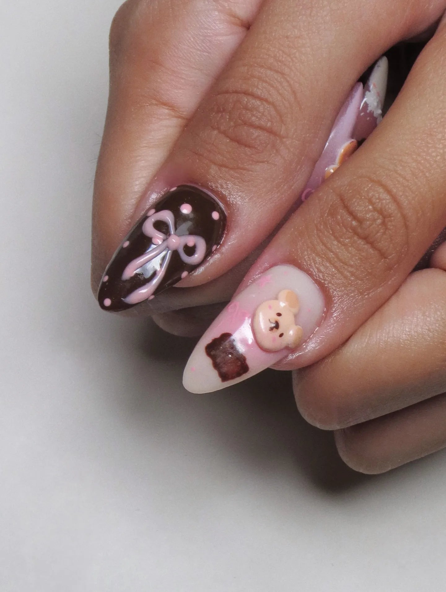 Handmade pink and brown 3D teddy bear and bow press-on nails with polka dot accents