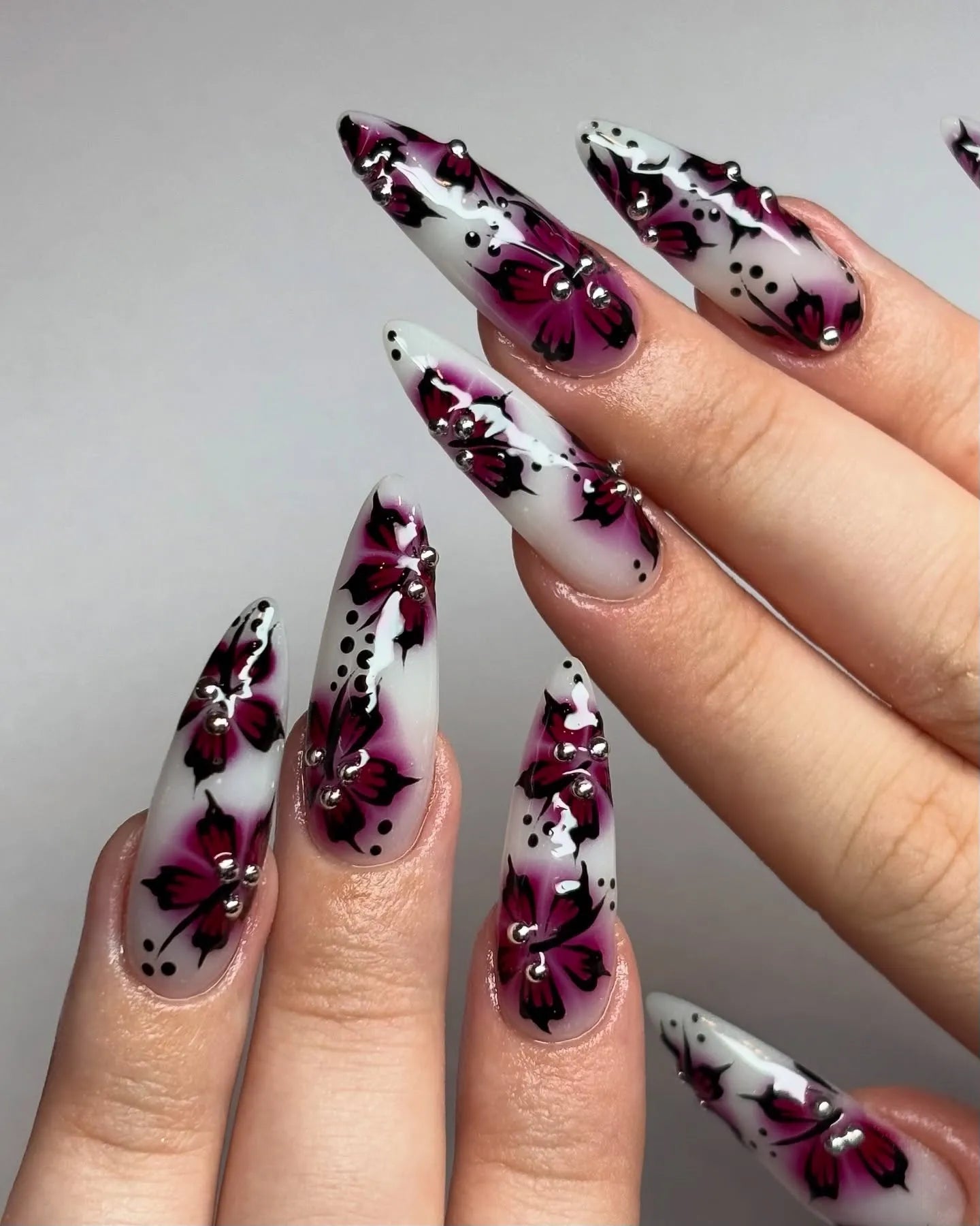 Handmade long press-on nails with pink butterfly floral art and rhinestone accents, elegant style