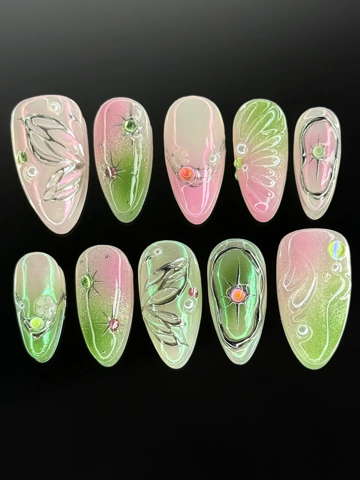 Handmade pink and green fairycore press-on nails with chrome butterfly wing designs and gems