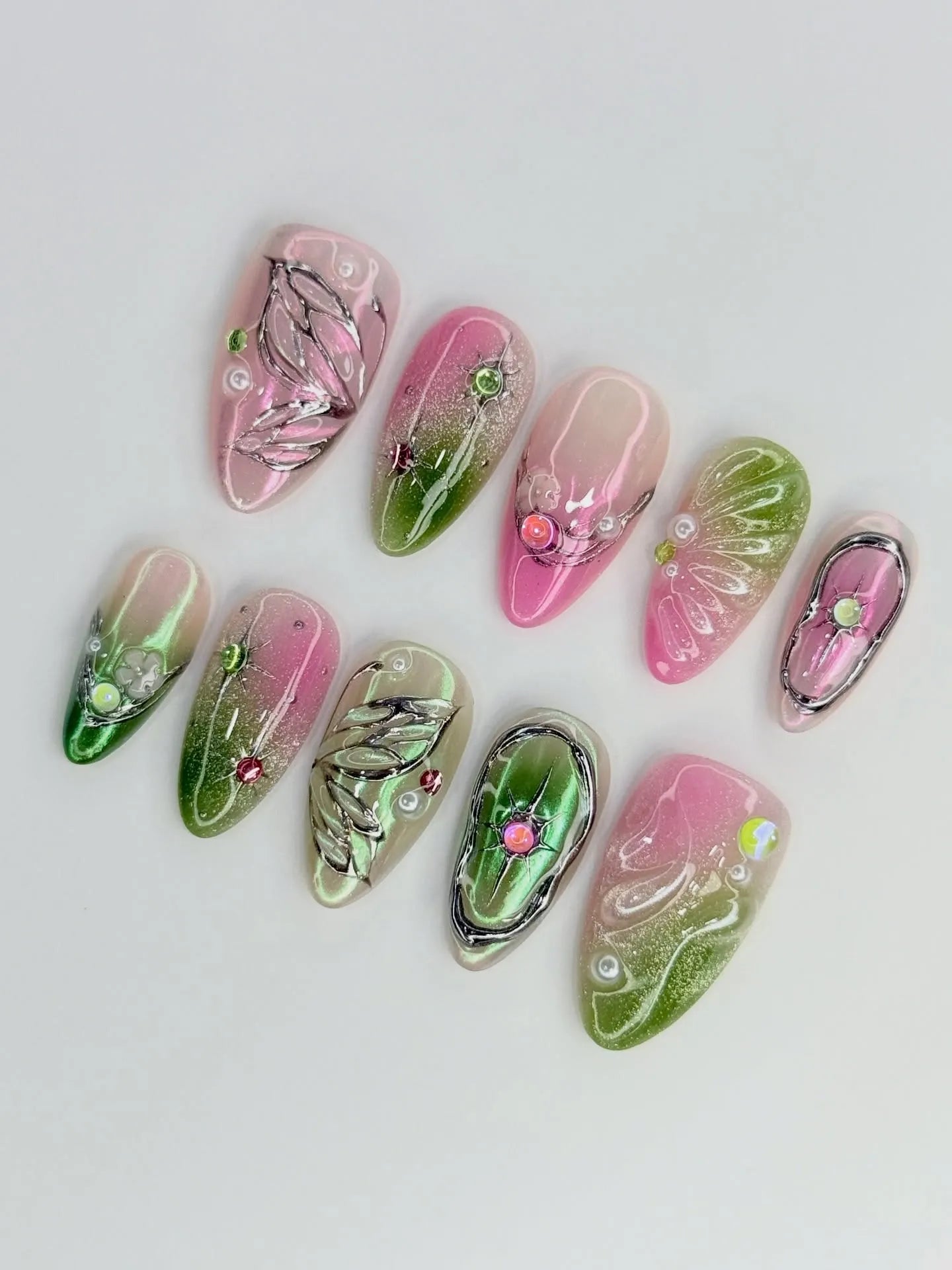 Handmade pink and green fairycore butterfly wing press-on nails with chrome details and gems