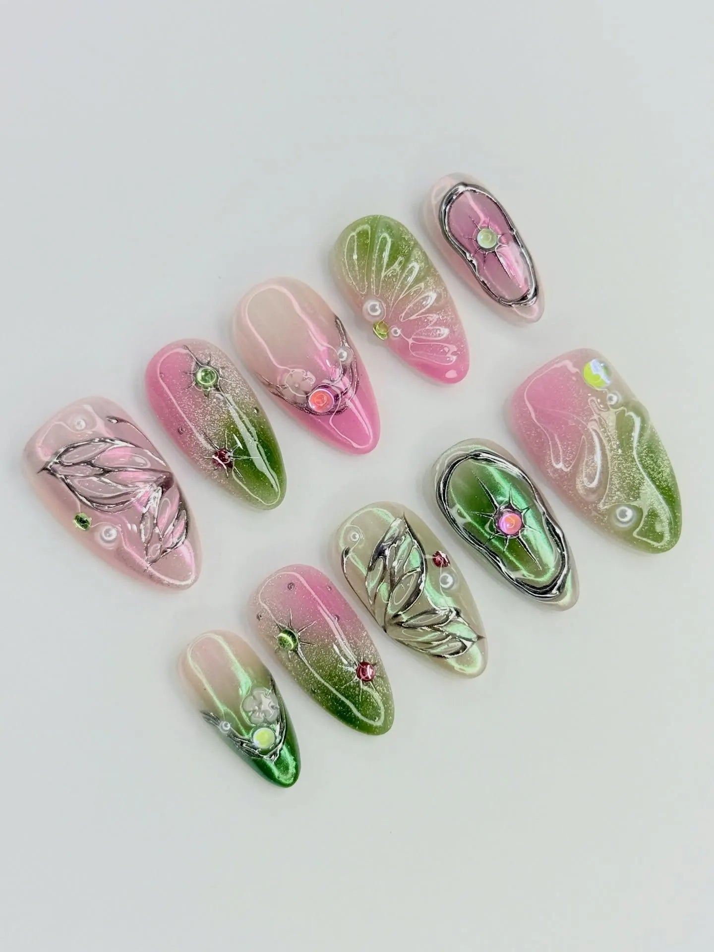 Handmade pink and green fairycore butterfly wing press-on nails with chrome accents and gems