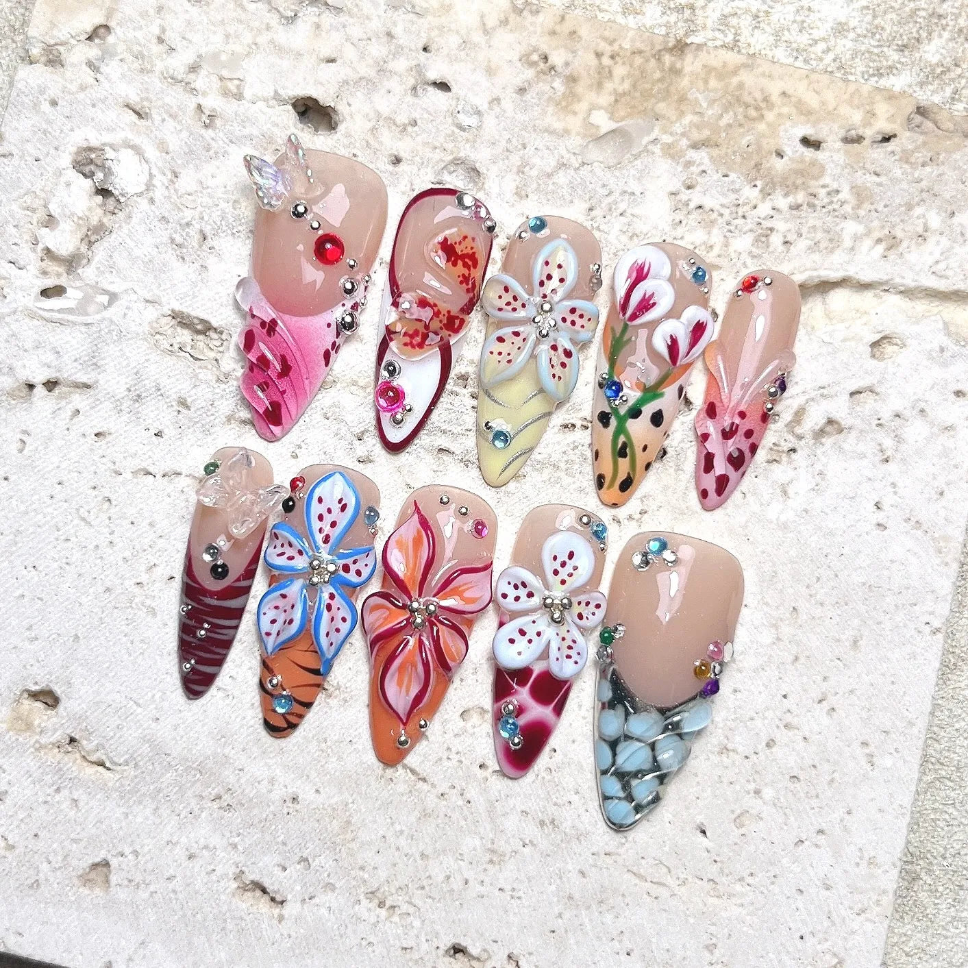 Handmade press-on nails with 3D butterfly, jellyfish, seashell and floral designs, embellished with rhinestones.