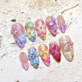Handmade 3D press-on nails with colorful floral designs and butterfly accents