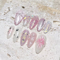 Handmade pink press-on nails with 3D bow, butterfly, shell, star, and pearl designs