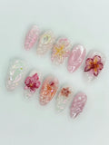 Handmade pink iridescent press-on nails with 3D orchid flower and pearl accents