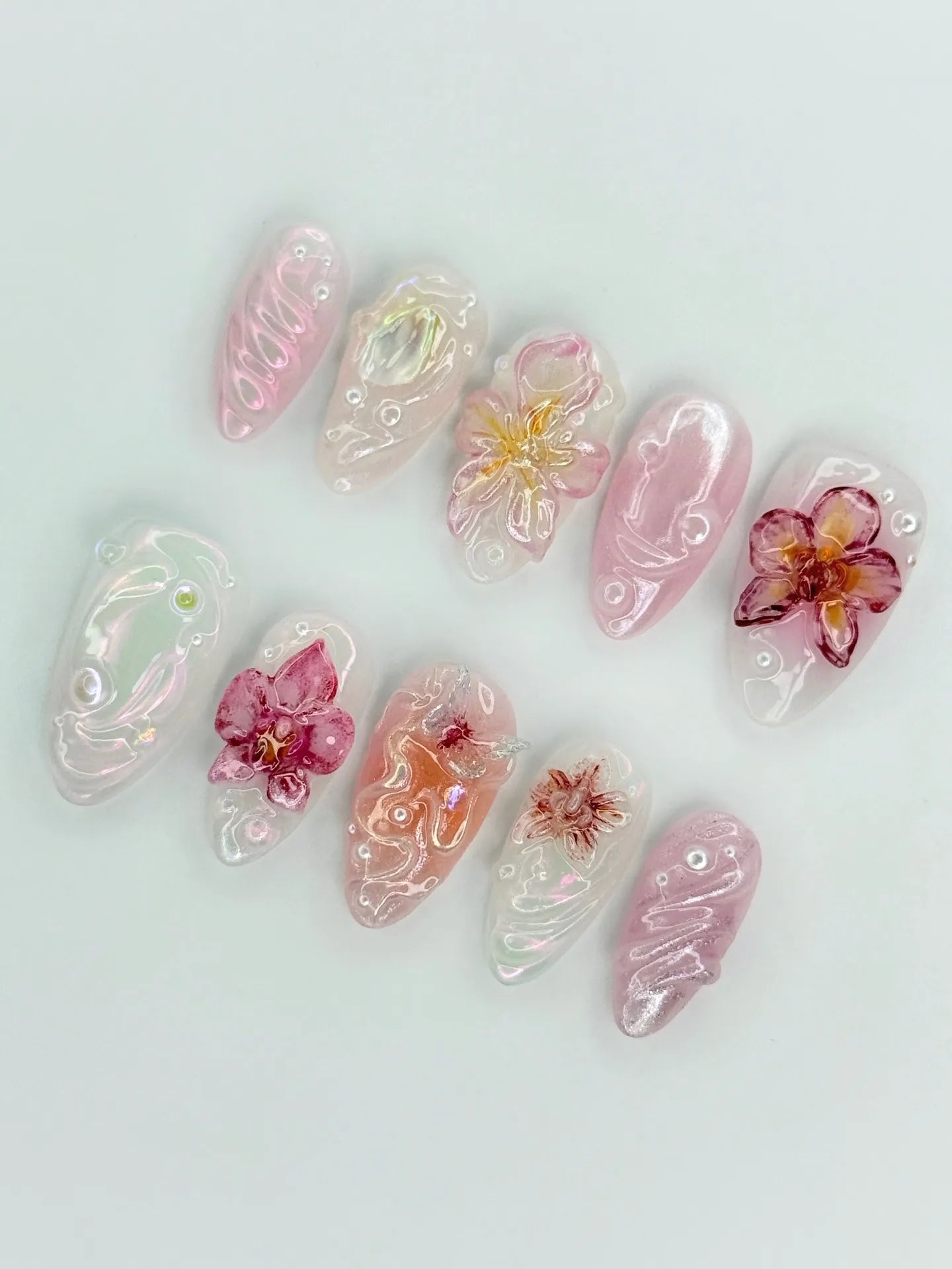 Handmade pink iridescent press-on nails with 3D orchid flower and pearl accents