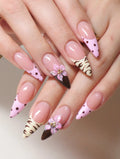 Handmade press-on nails with pink polka dots, animal print, and 3D floral accents.