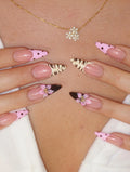 Handmade press-on nails with pink polka dots, animal print, and 3D flower designs.