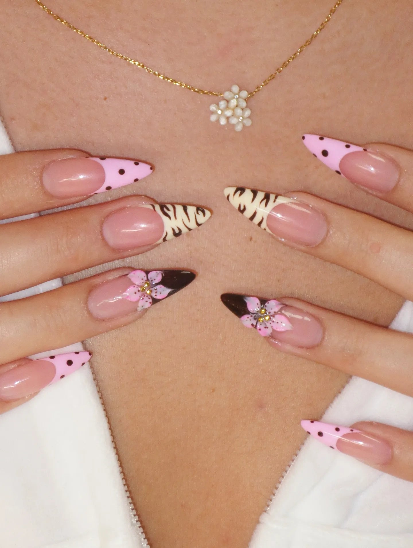 Handmade press-on nails with pink polka dots, animal print, and 3D flower designs.