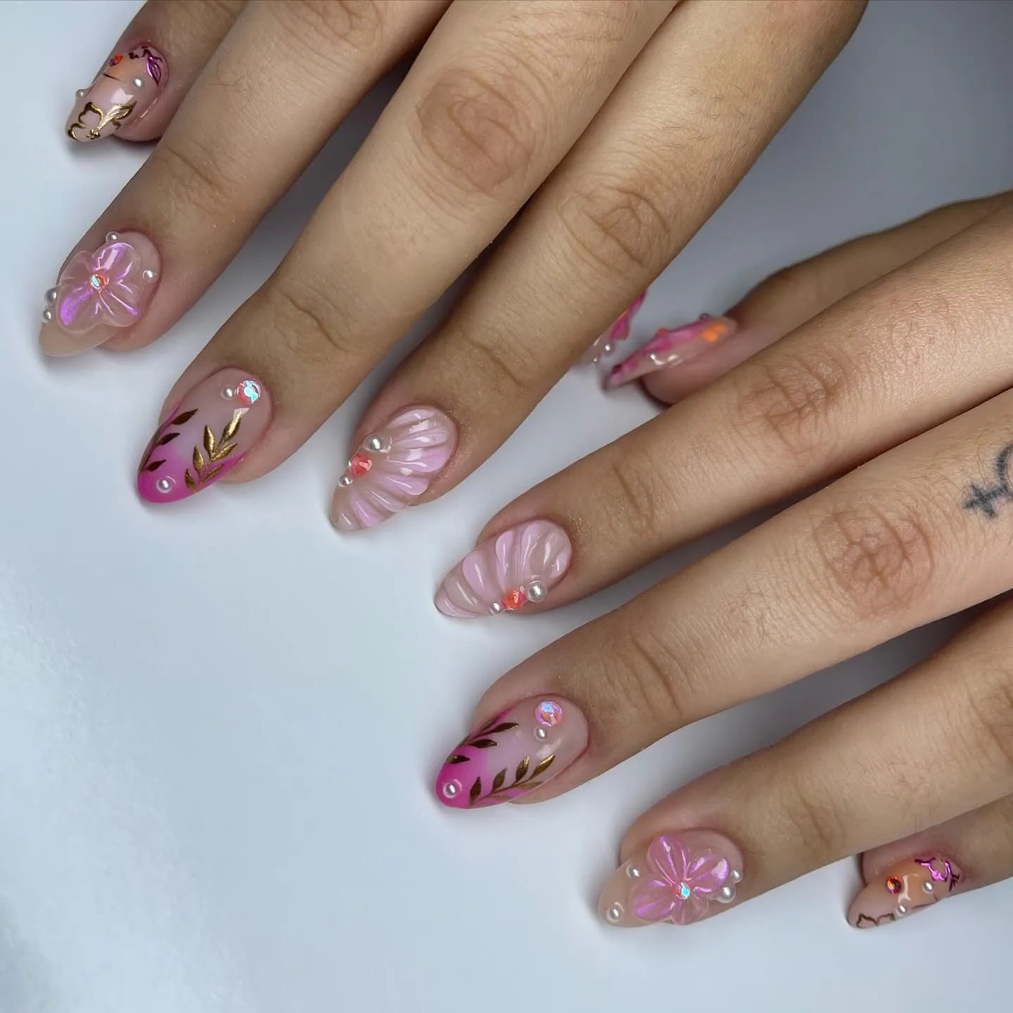 Handmade pink shell floral press-on nails with gold leaf and pearl accents