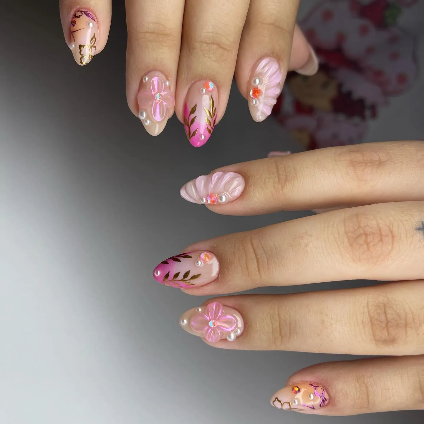Handmade pink floral shell press-on nails with gold leaf accents and pearl details