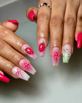 Handmade pink press-on nails with strawberry, 3D flower, bunny, and bow designs
