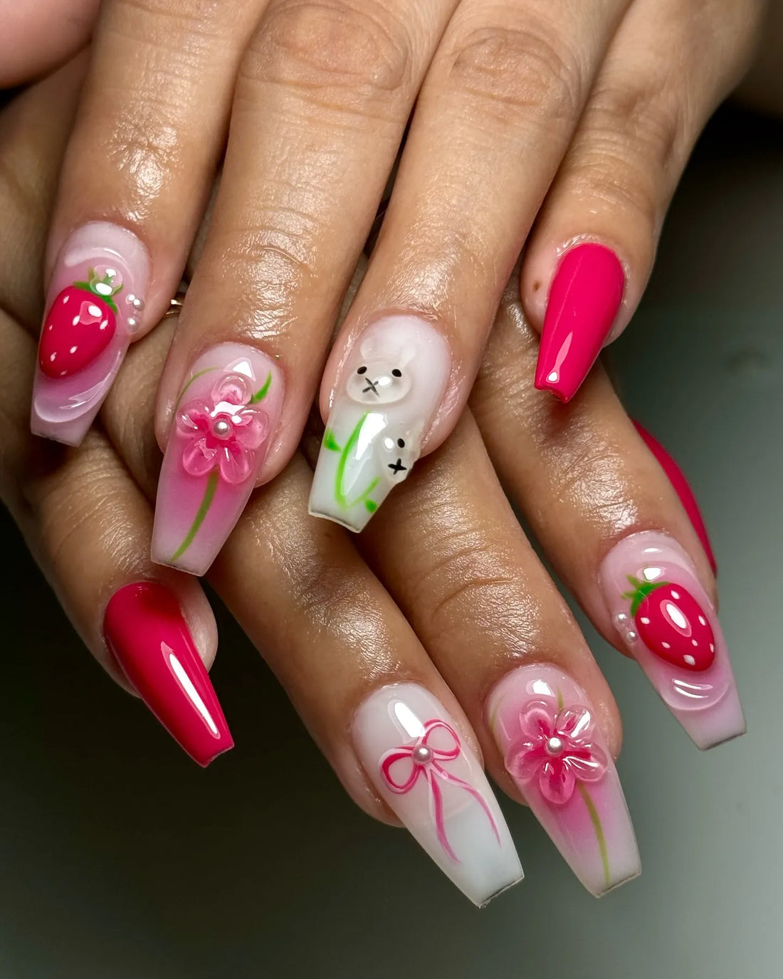 Handmade press-on nails with 3D pink flowers, strawberries, bunny, and bow designs