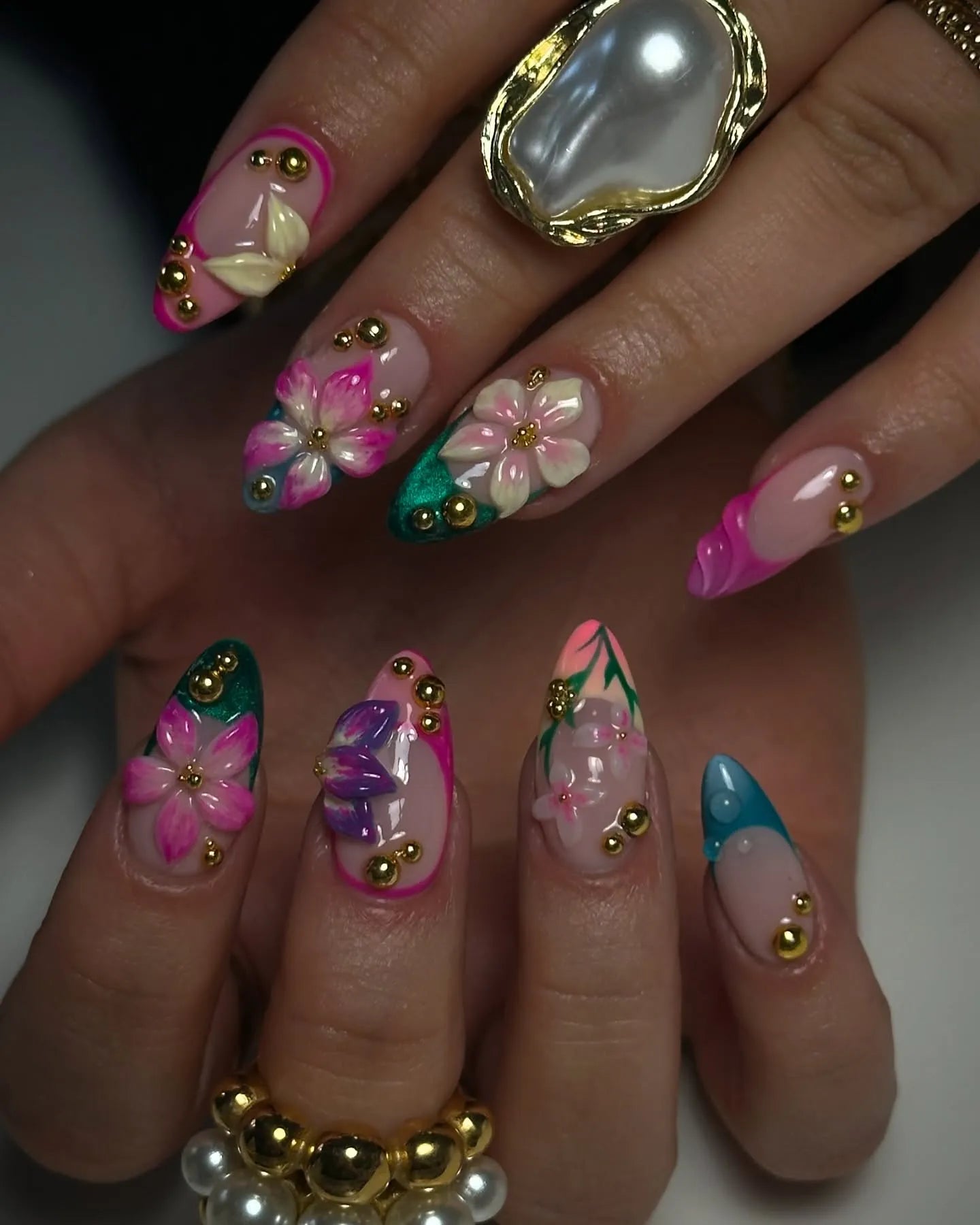 Handmade press-on nails with 3D pink, teal, and green floral designs and gold accents