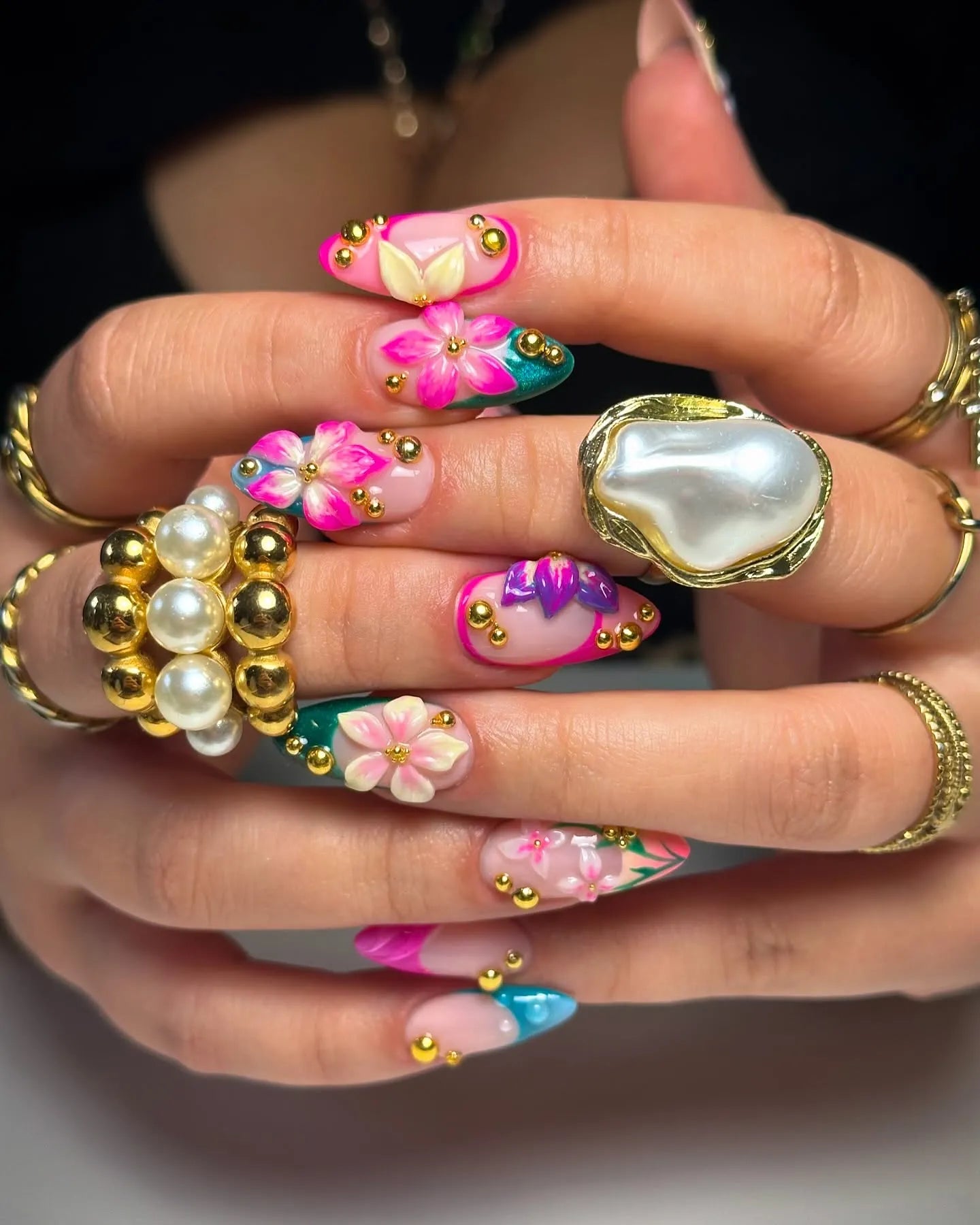 Handmade press-on nails with 3D pink, teal, and green floral designs and gold accents.