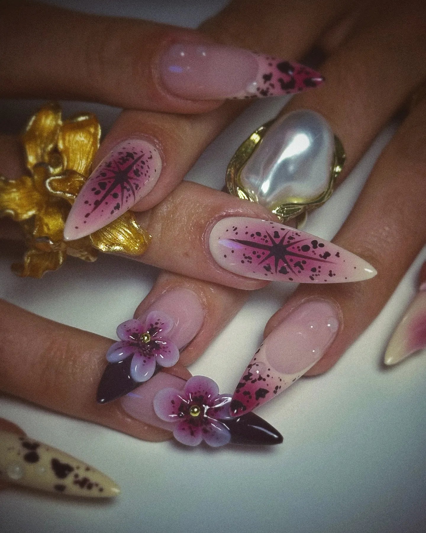 Handmade purple floral press-on nails with 3D galaxy star designs and ombre details.