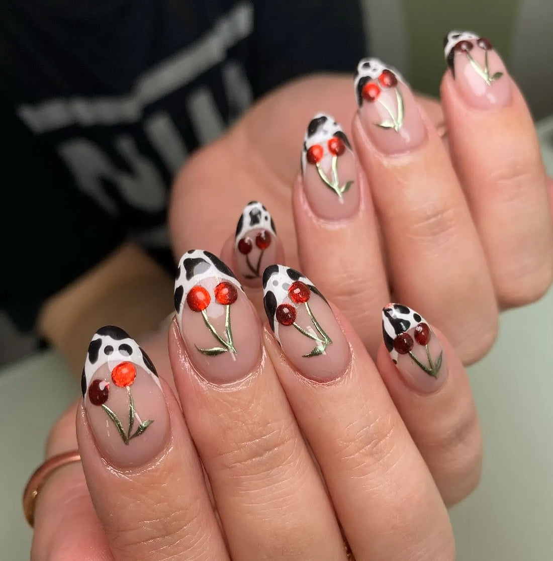 Handmade French press-on nails with red cherry and cow print animal pattern design.