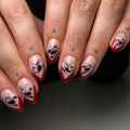 Handmade press-on nails with red French tips, silver shimmer, and black scorpion designs.