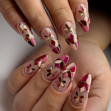 Handmade press-on nails with red mosaic floral design and gold outline, almond shape