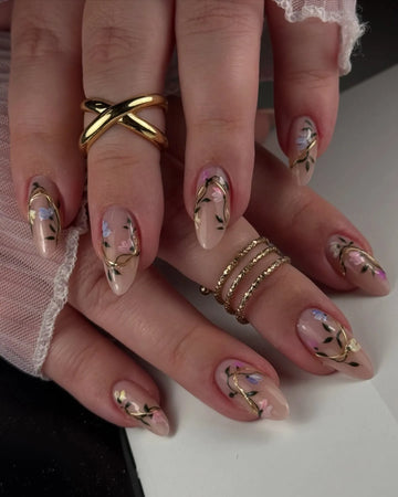 Handmade nude press-on nails with pink and blue floral design and gold vine accents.