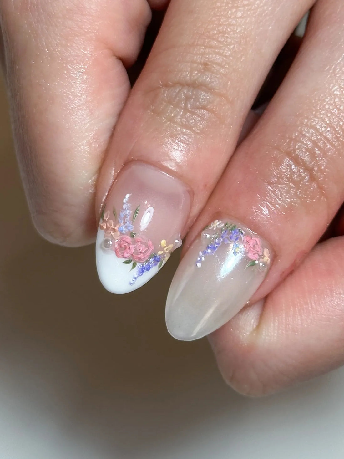 Handmade pastel floral press-on nails with gold accents and white French tips